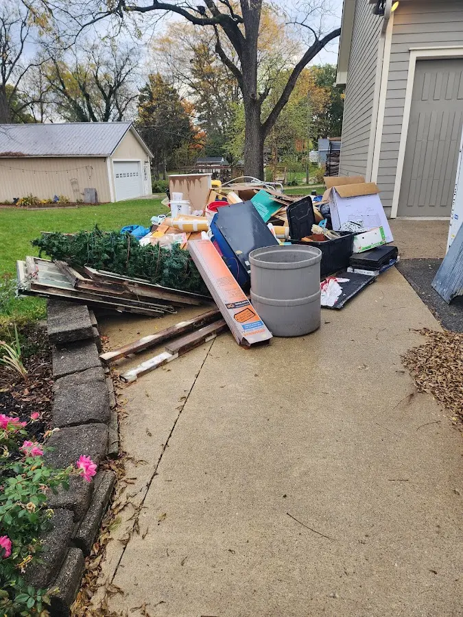Dumpster being loaded with debris for 10 Yard Dumpster Rental in Deephaven